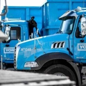 a line up of YORK1 roll off trucks