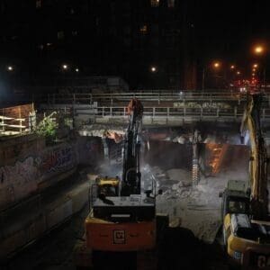 Night shot of 2 YORK1 excavators demolishing an urban bridge